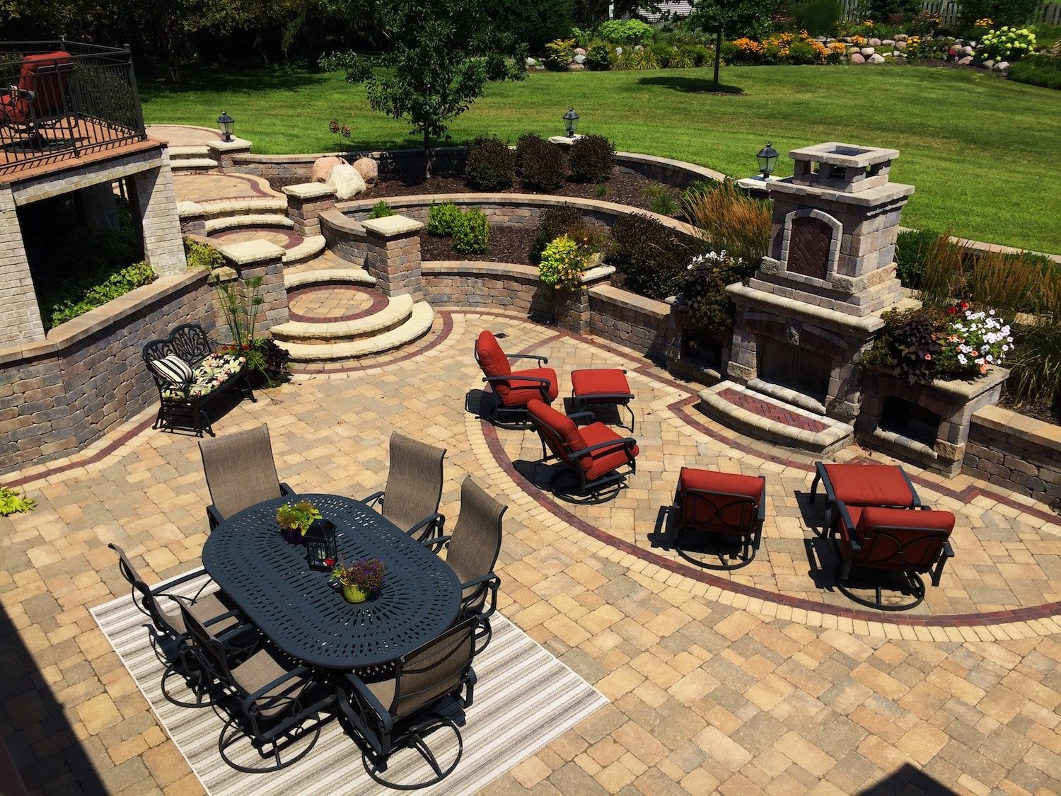 Patio with outdoor dining set, fireplace, seating area, and landscaping.
