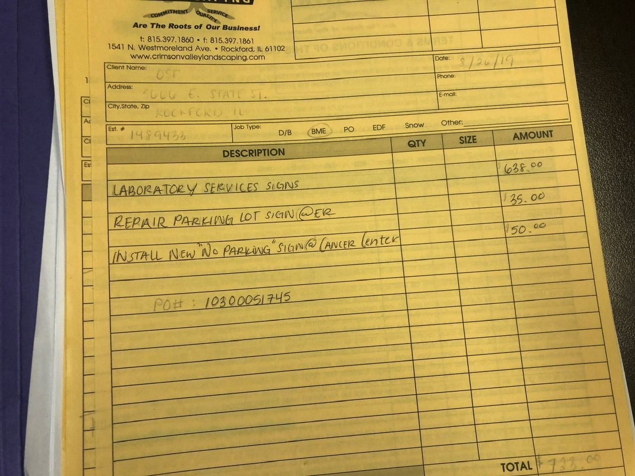 A filled-out, yellow multi-part carbon copy invoice form with handwritten medical service details and costs.