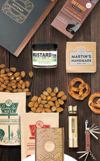 A wooden table topped with a variety of snacks including mustard and martin 's handmade cheese