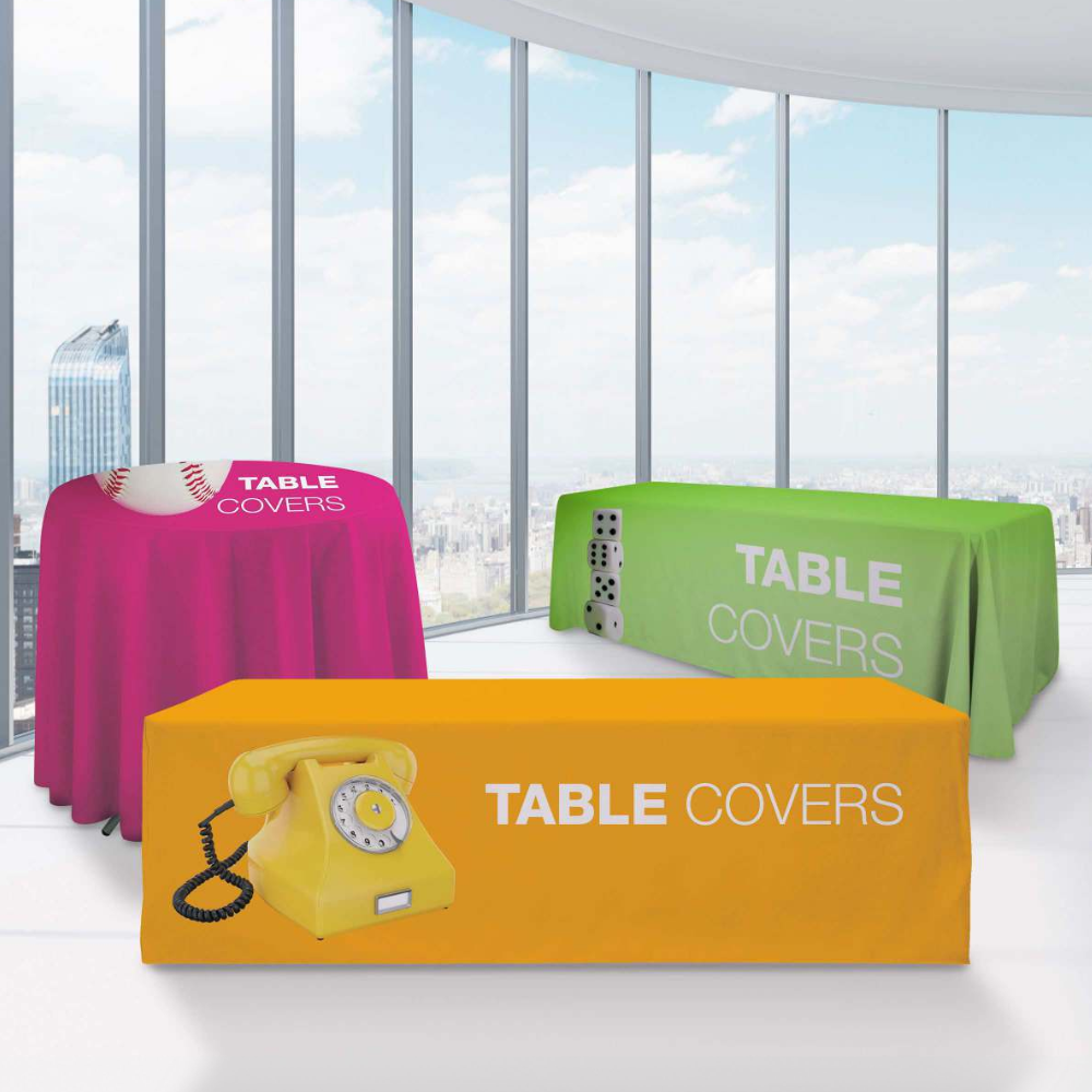 Three table covers are sitting on a table in front of a window.