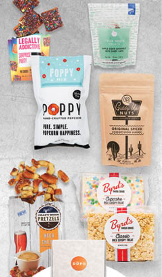 A table topped with a variety of snacks including poppy popcorn