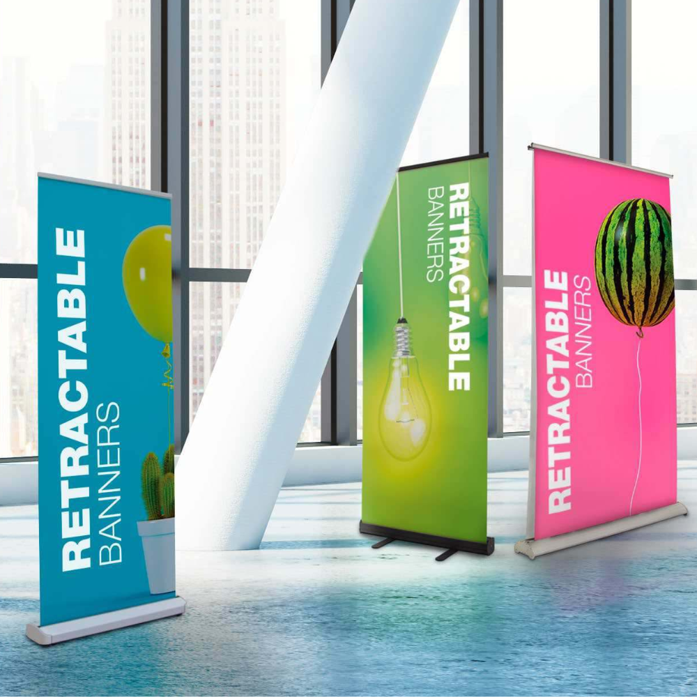 Three retractable banners are sitting in front of a window