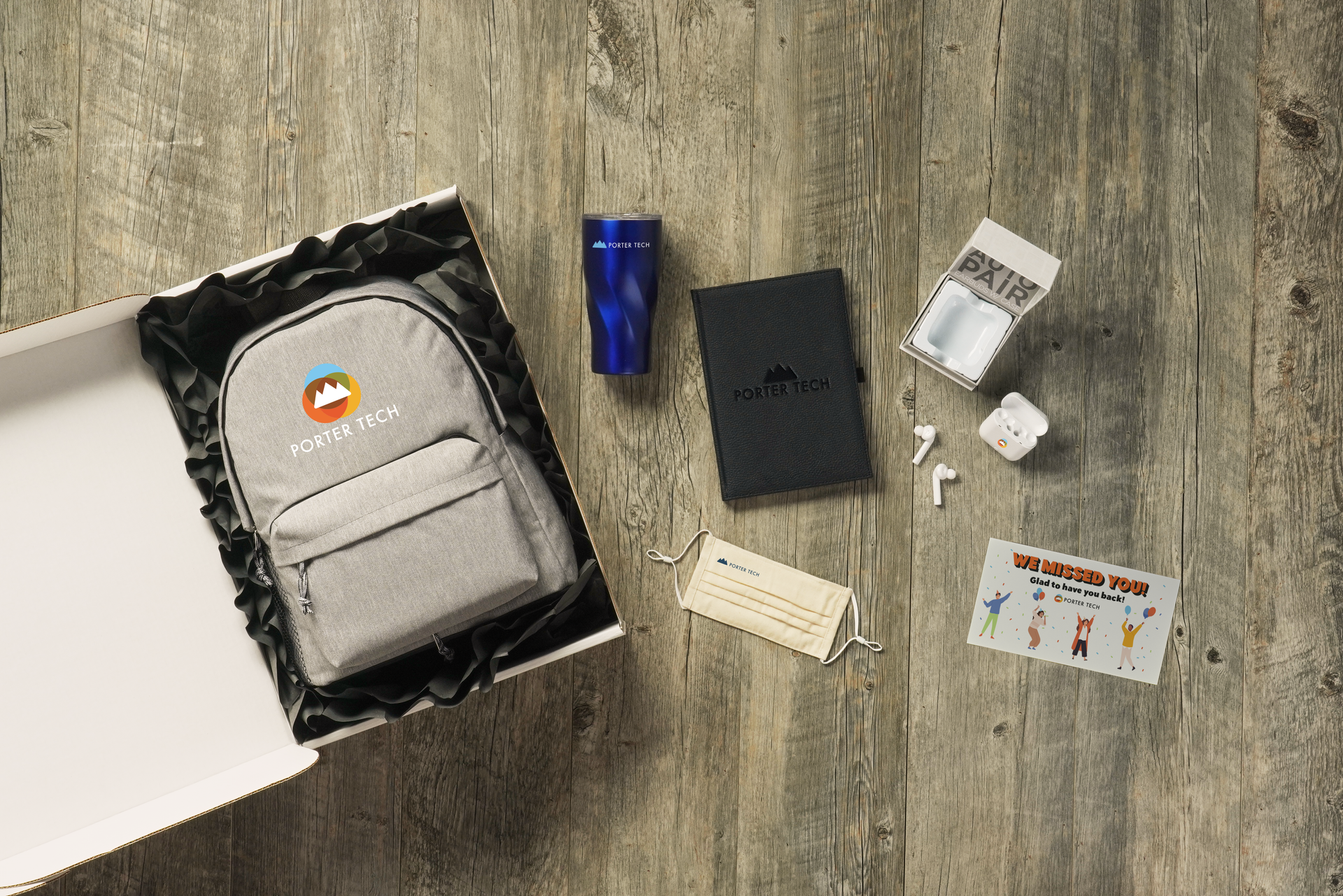 A backpack is sitting inside of a box on a wooden table.