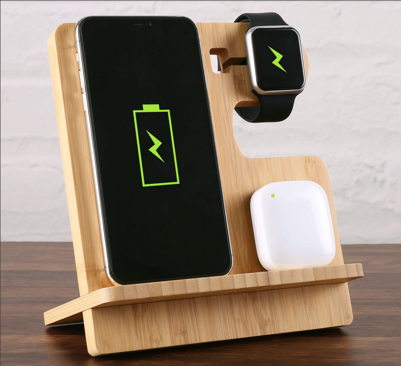 A phone , watch , and airpods are sitting on a wooden stand.