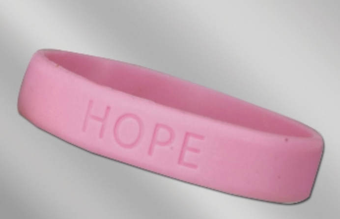 A pink bracelet that says hope on it