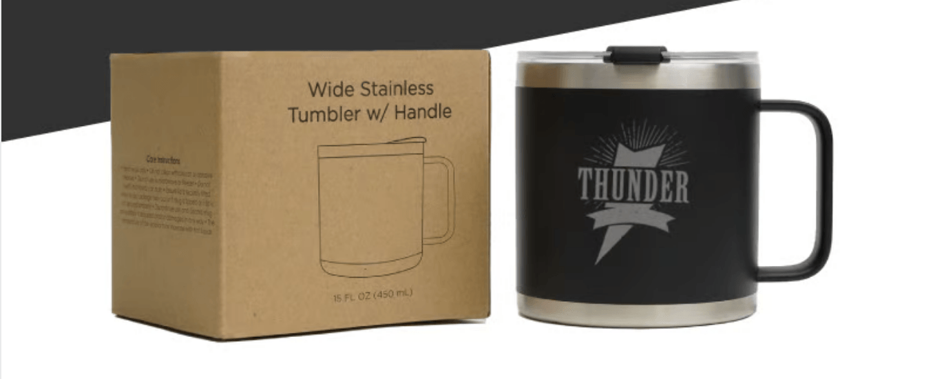 A stainless steel mug with a handle and a box next to it.