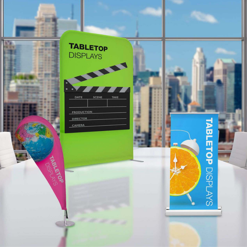 A green tabletop display with a clapper board on it