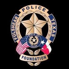 Fulshear Texas Police Foundation badge featuring a star, flags, wreath, and text on a black background.