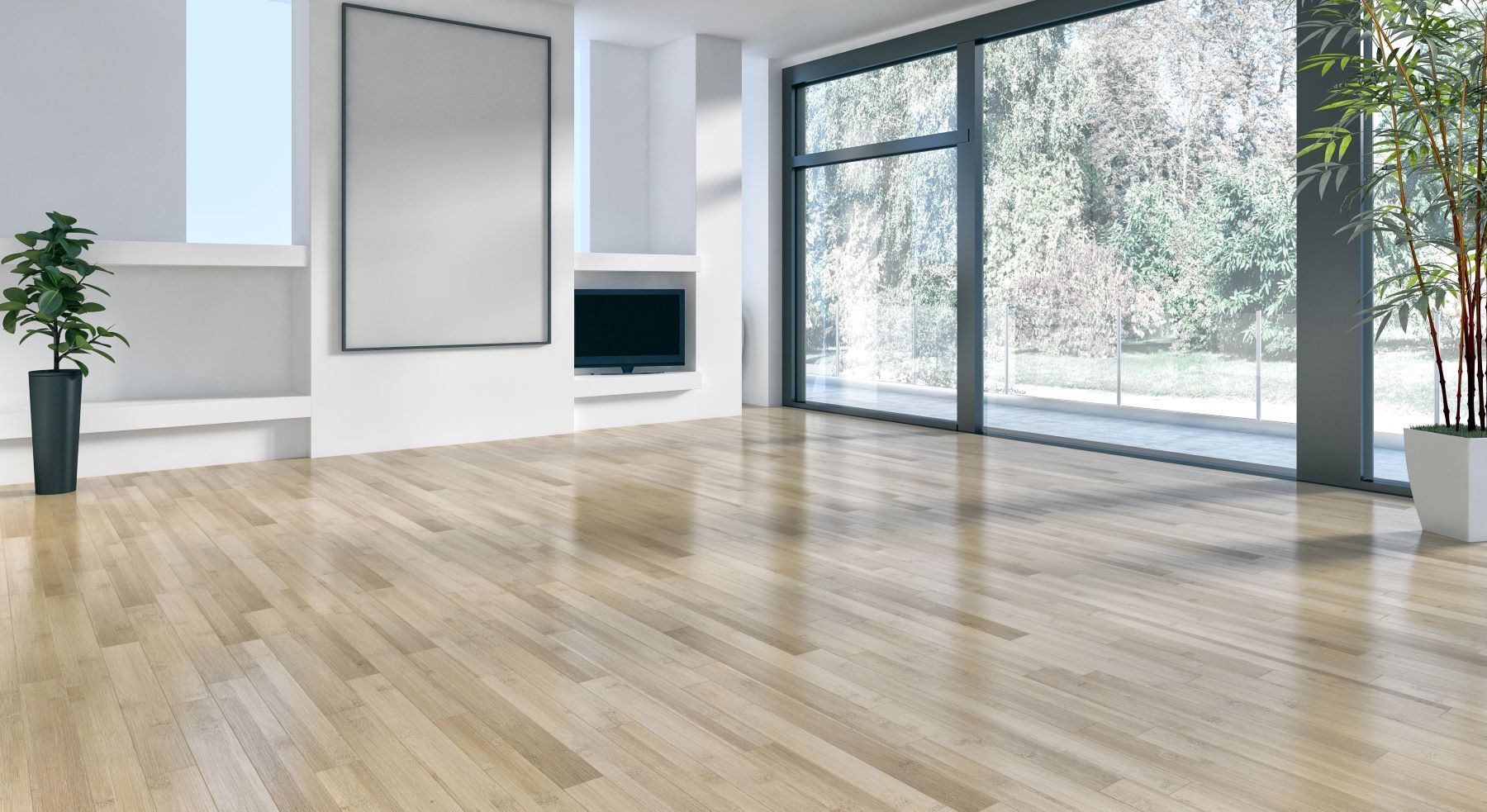 An empty living room with a wooden floor and lots of windows.