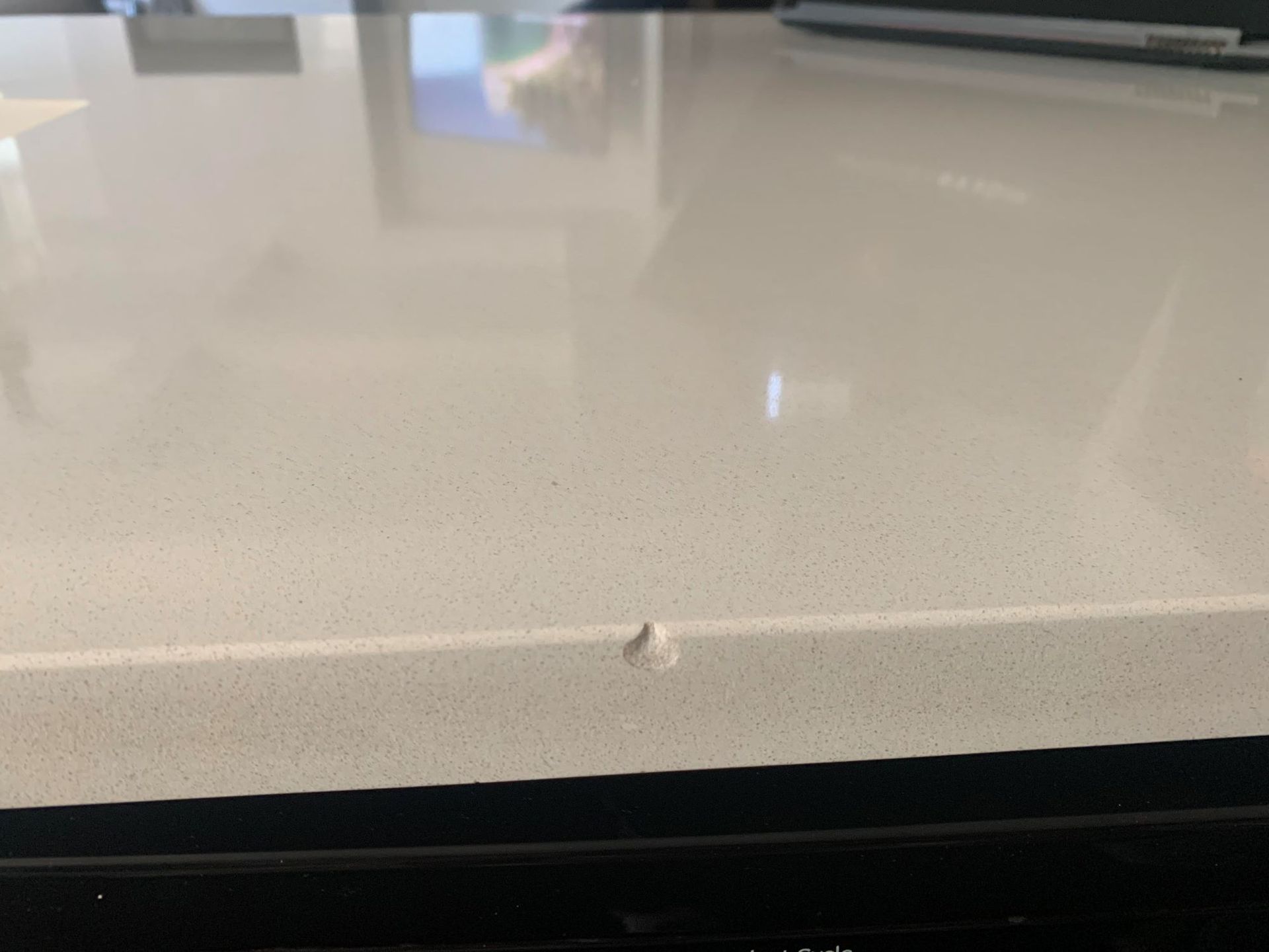 A close up of a white counter top with a hole in it.