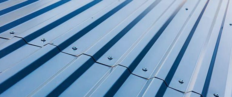 Blue corrugated metal roof with dark shadows.