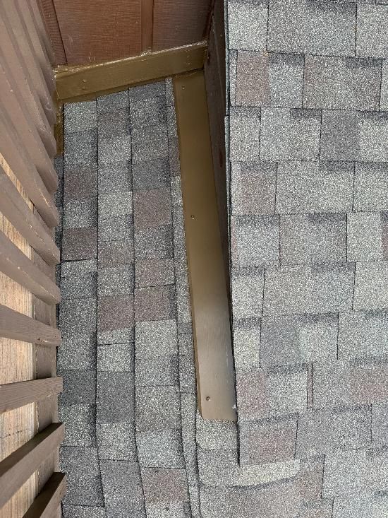 A close up of a roof with a wooden fence in the background.