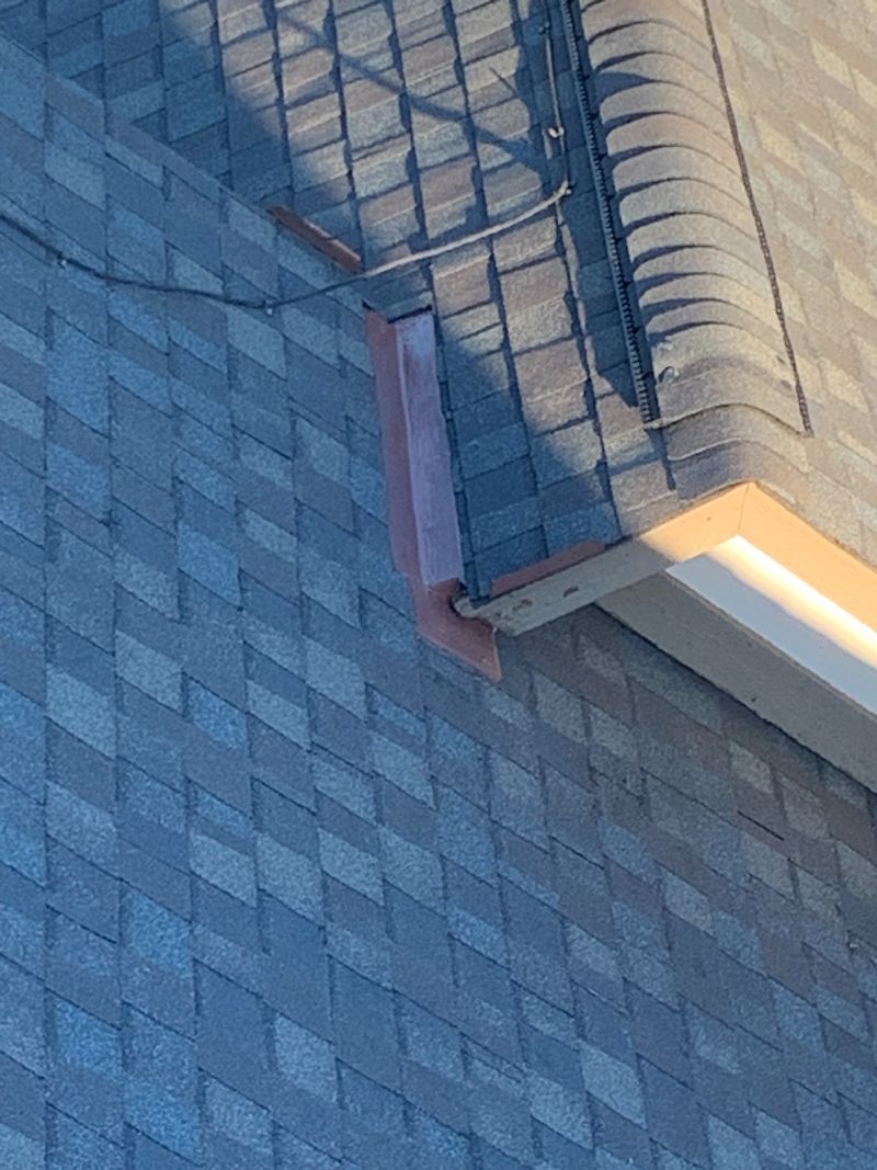 A close up of a roof with a gutter on it.
