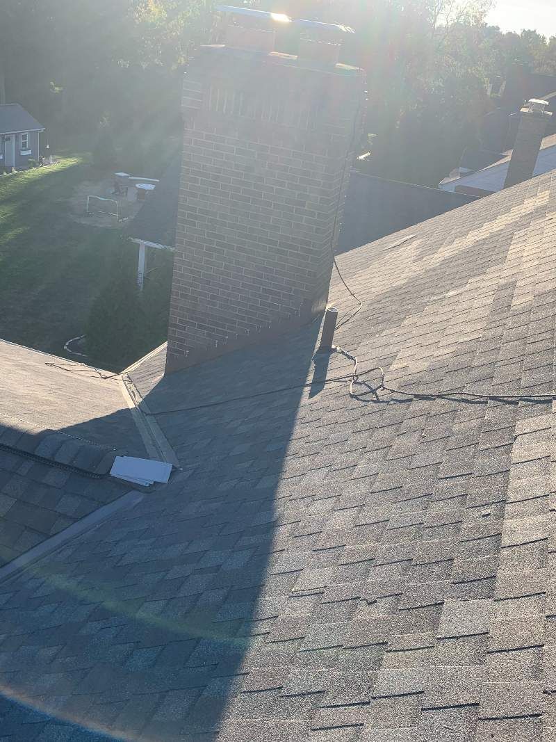 A close up of a roof with a shadow on it.