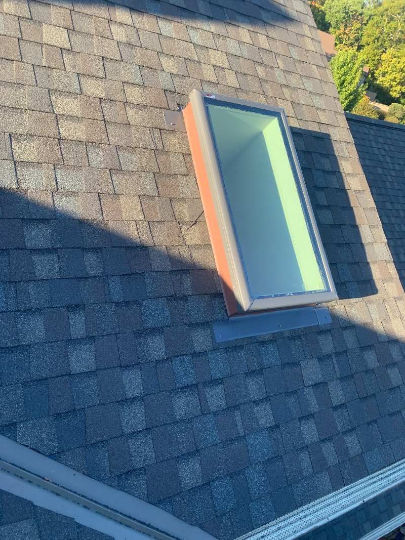 There is a skylight on the roof of a house.