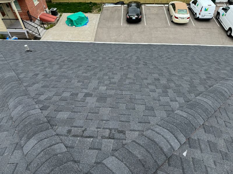 A roof with a lot of shingles and cars parked on it