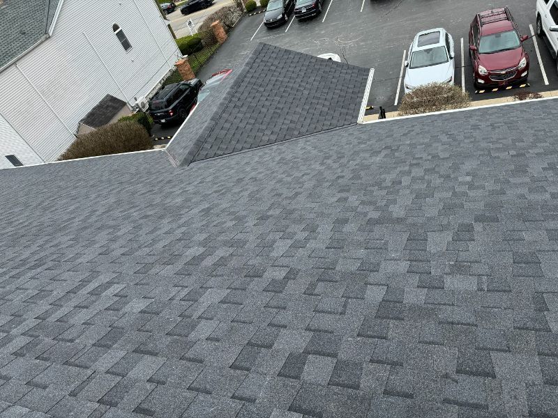 A roof with a lot of shingles and cars parked on it.
