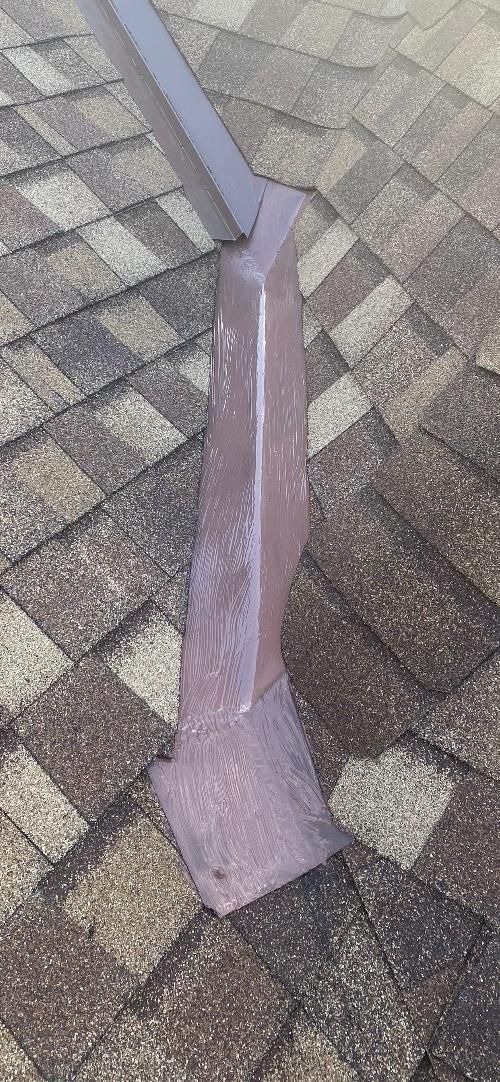 A purple pole is sitting on a brick sidewalk.