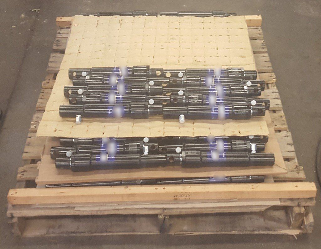 Several Small Back Snow Plow Cylinders On A Pallet