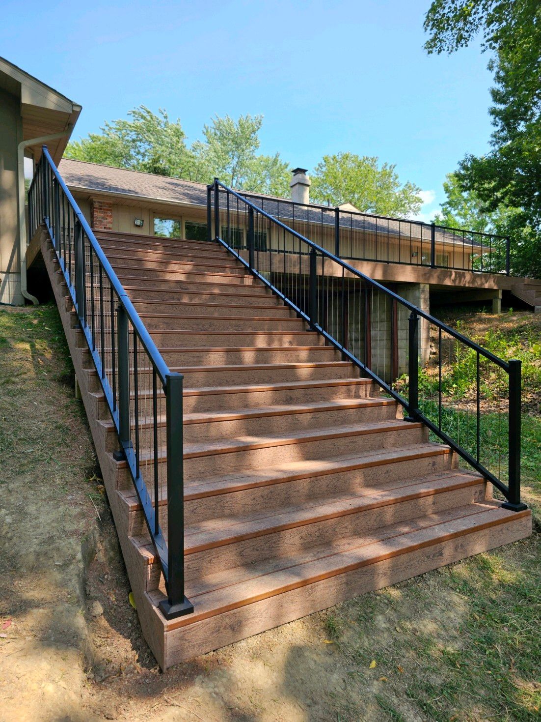 Stairs leading up to a house with a metal railing