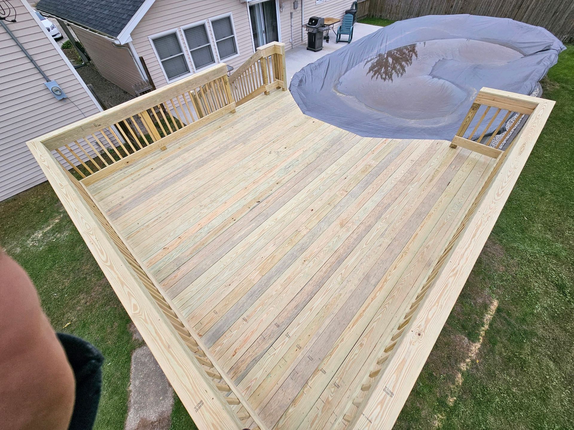 A wooden deck with a pool