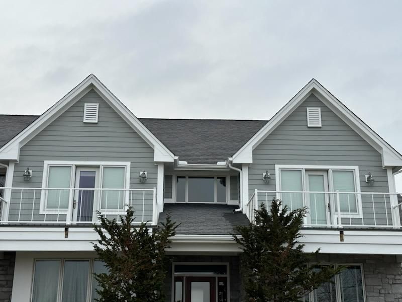 Large house with gray siding and white trim