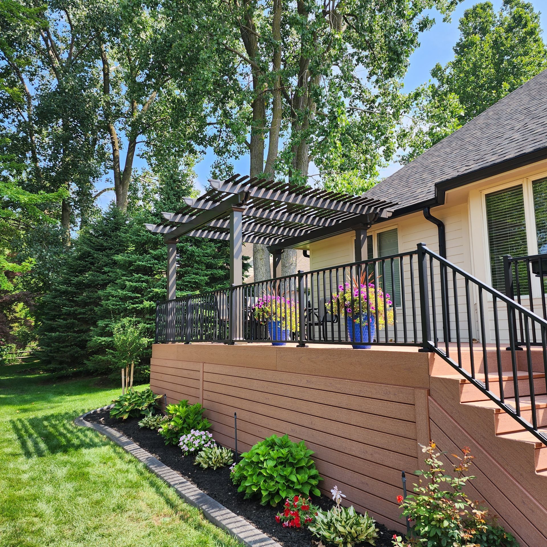 A house with a deck and stairs in the backyard