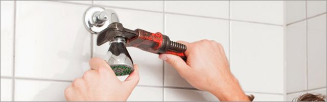 A plumber fixing a shower