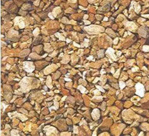 Close-up of small tan, brown, and white gravel stones filling the frame.