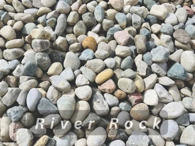 Close-up of smooth gray and tan river rocks filling the frame.