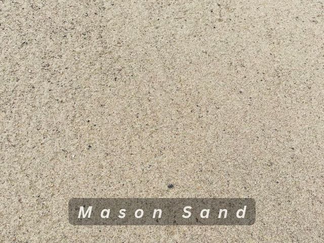Light tan mason sand with a small label at the bottom.