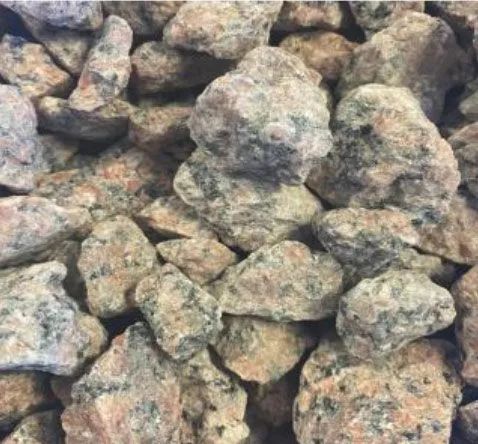 Pile of irregular gray and tan rocks stacked closely together