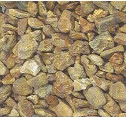 A pile of small tan and brown rocks filling the frame