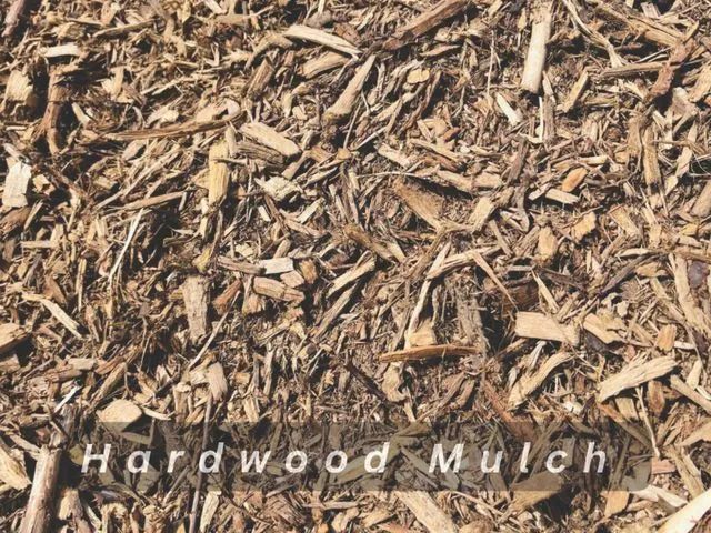Close-up of tan hardwood mulch with scattered wood chips and the words “Hardwood Mulch” at the bottom.
