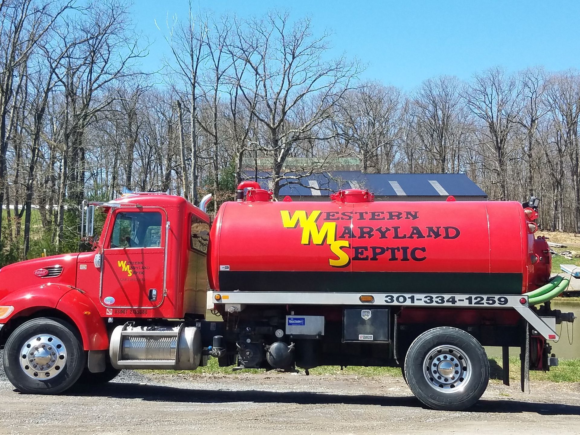 Red septic tank truck with