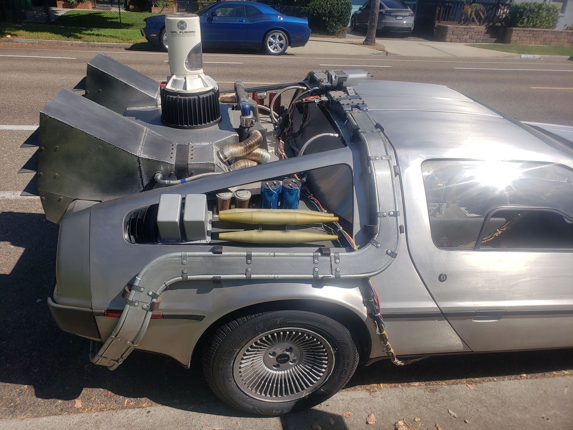 A back to the future car is parked on the side of the road