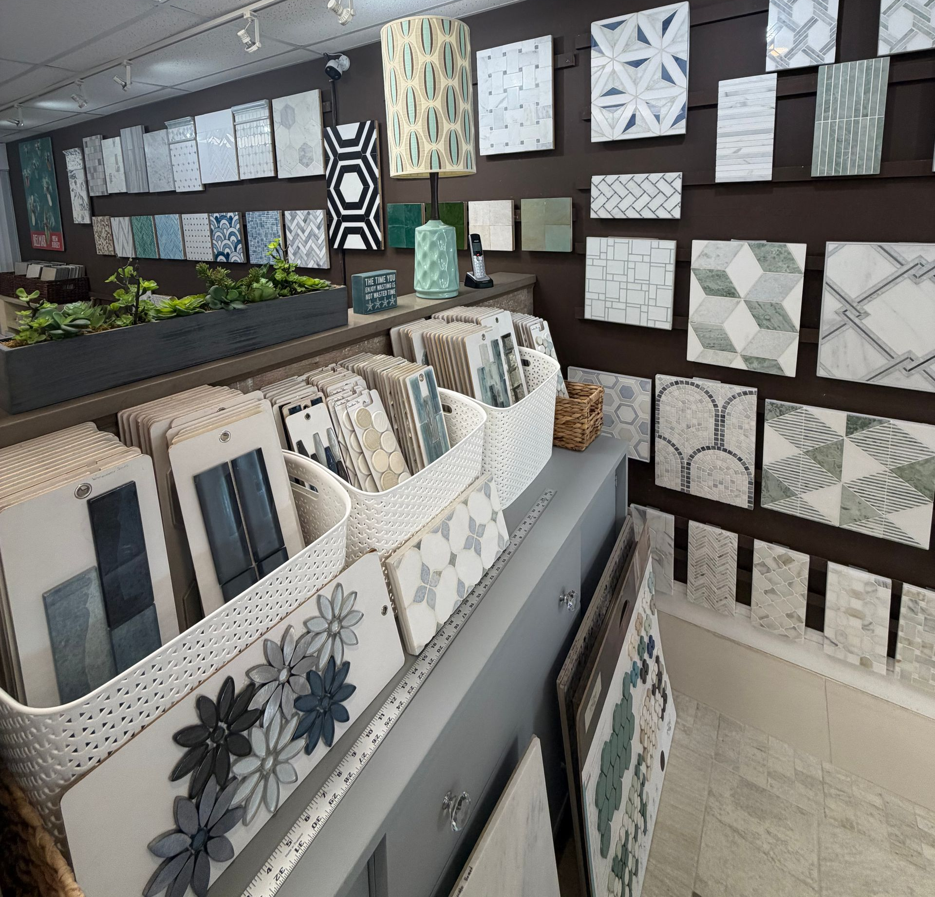 Interior of a showroom with many patterned tiles displayed on walls and racks