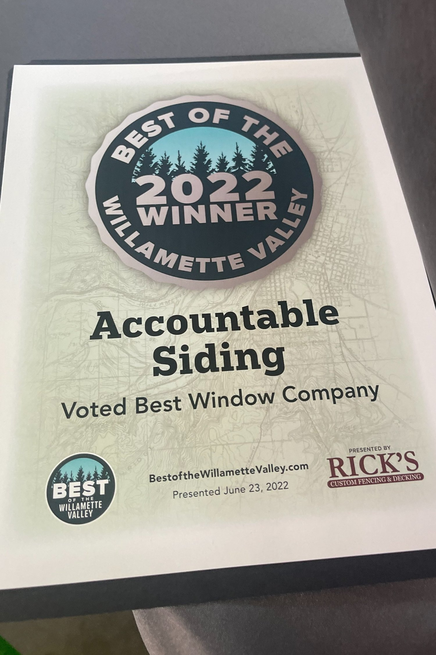 A certificate for accountable siding is sitting on a table.