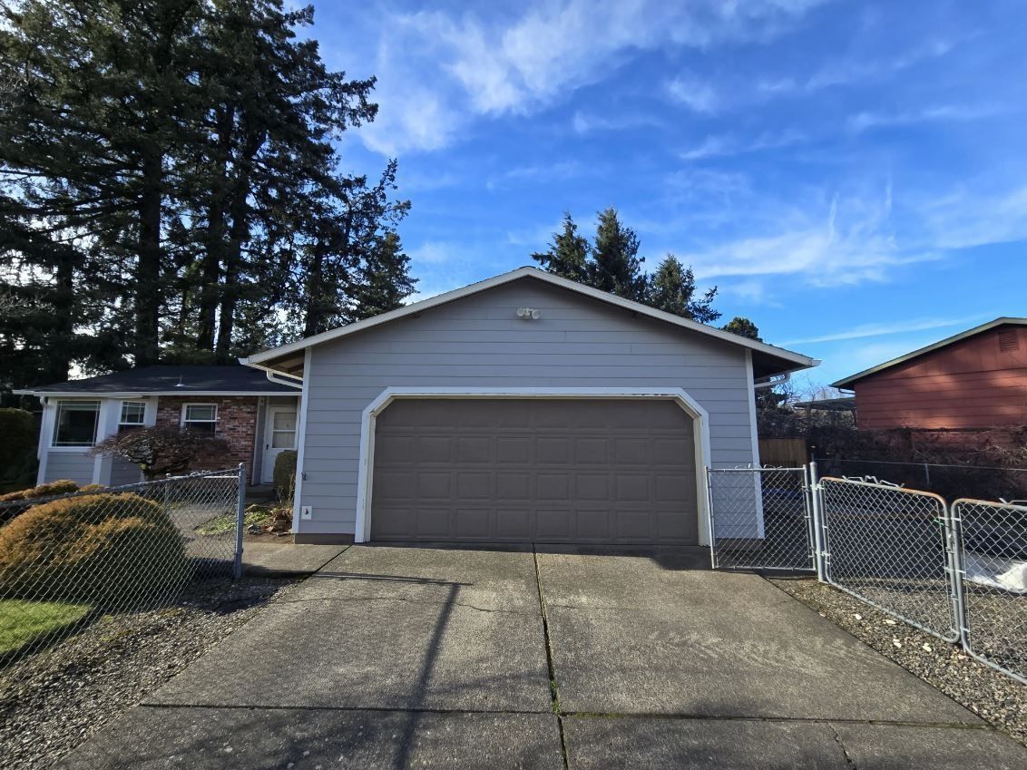 A garage with a chain link fence in front of it