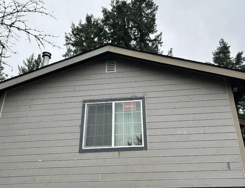A house with a window and a chimney on the roof