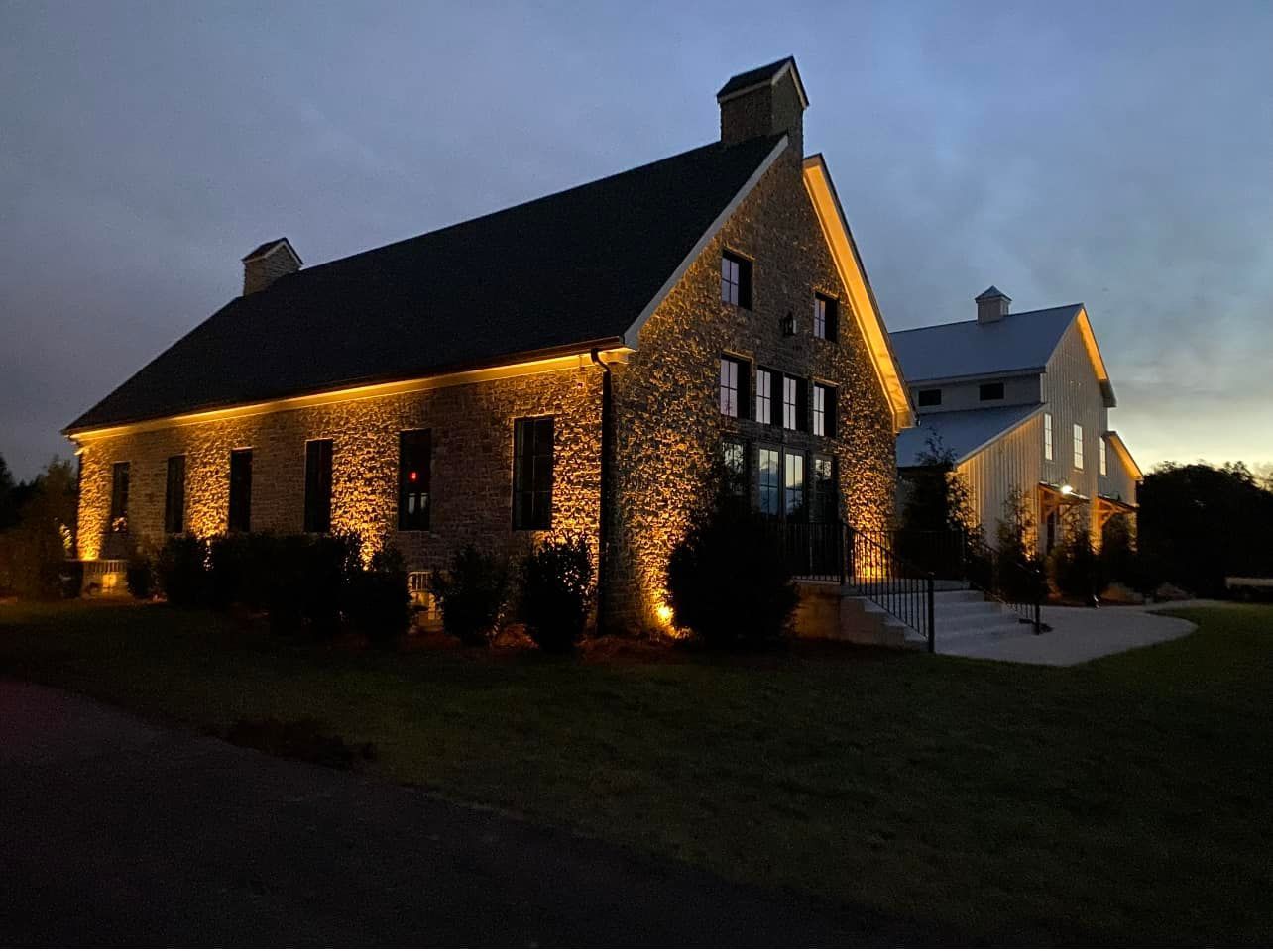 A large stone building is lit up at night.