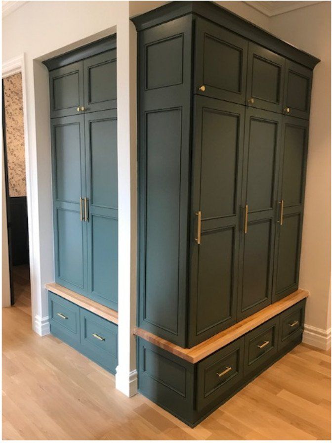 Dark blue built-in wardrobe cabinet with drawers in a room, shown from two angles.