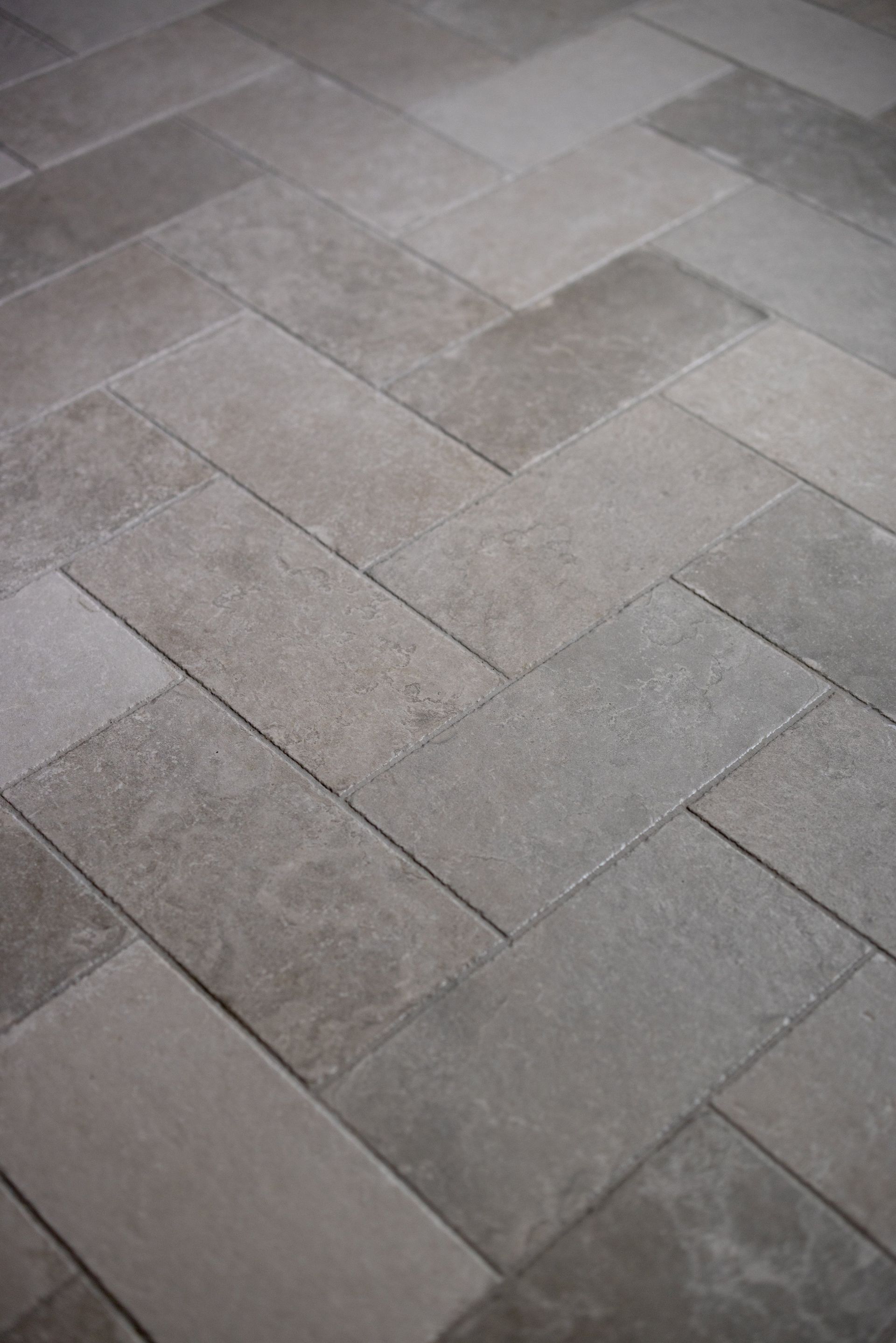 Gray stone pavement tiles arranged in a diagonal pattern