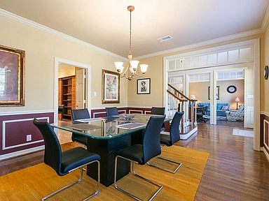 A dining room with a glass table and chairs