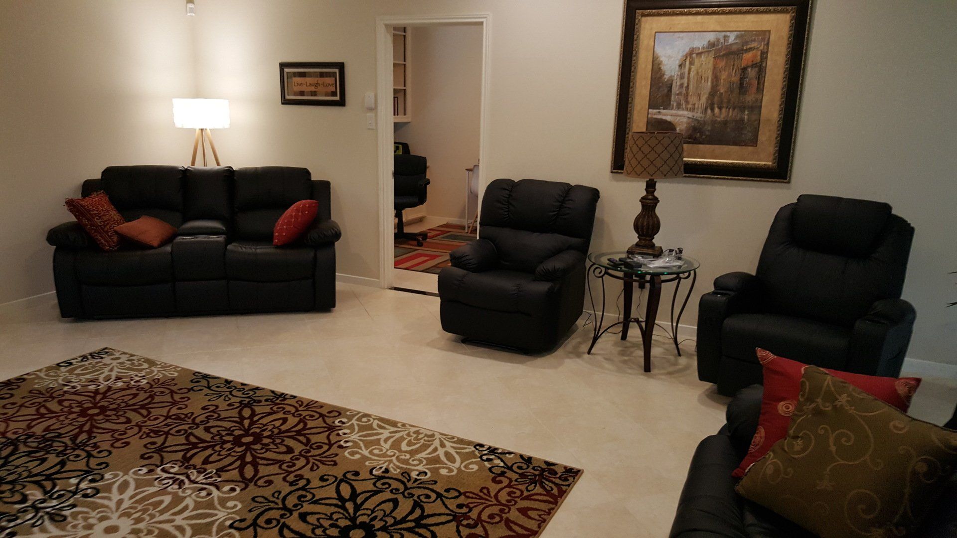 A living room with a couch and two chairs