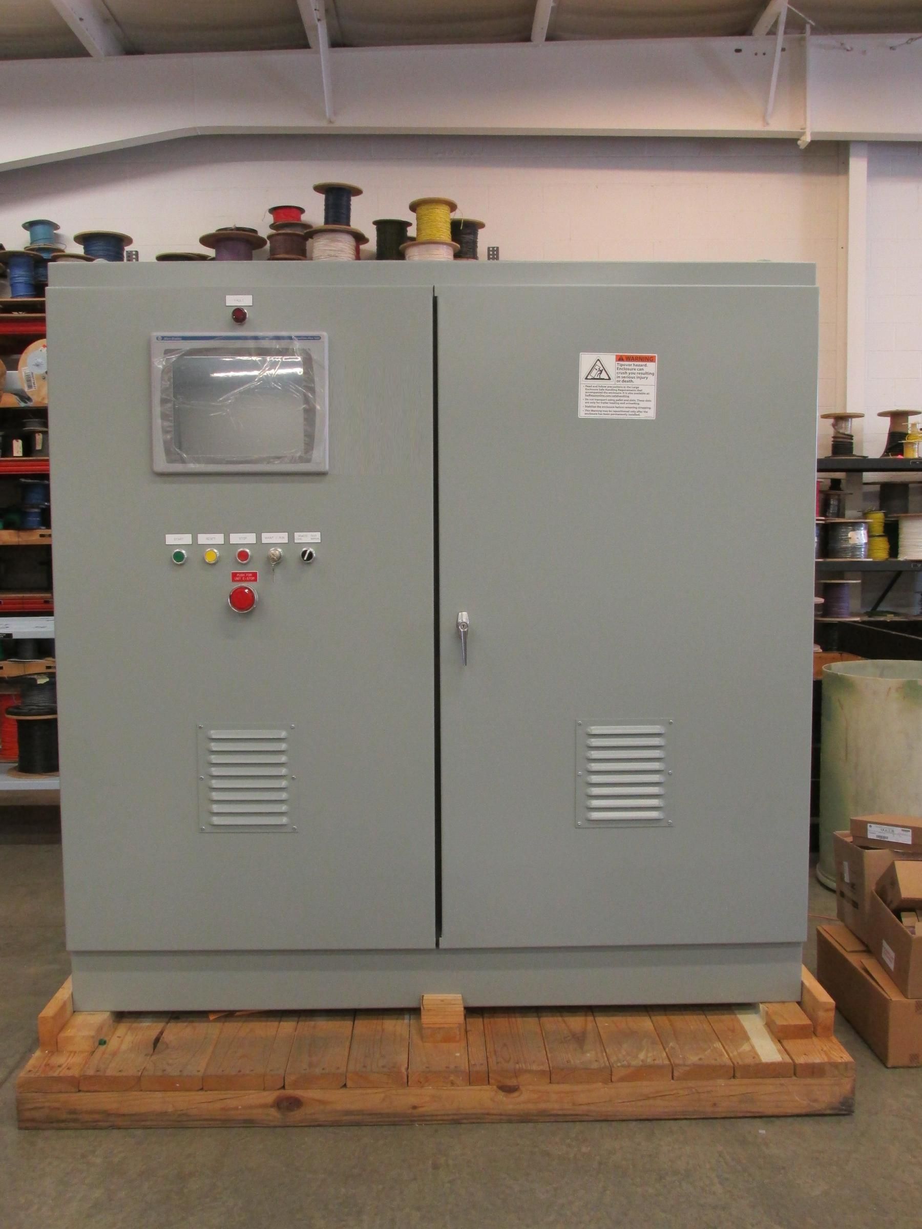 A large electrical cabinet is sitting on a wooden pallet