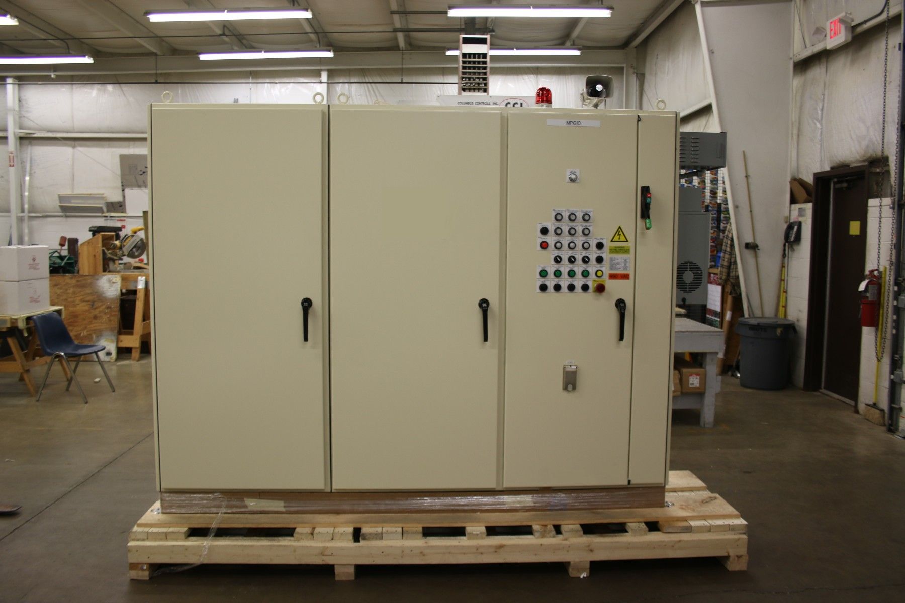 A large white box is sitting on a wooden pallet in a warehouse.