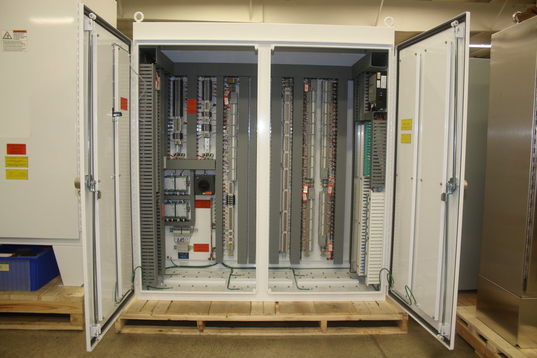 A large electrical cabinet is sitting on a wooden pallet