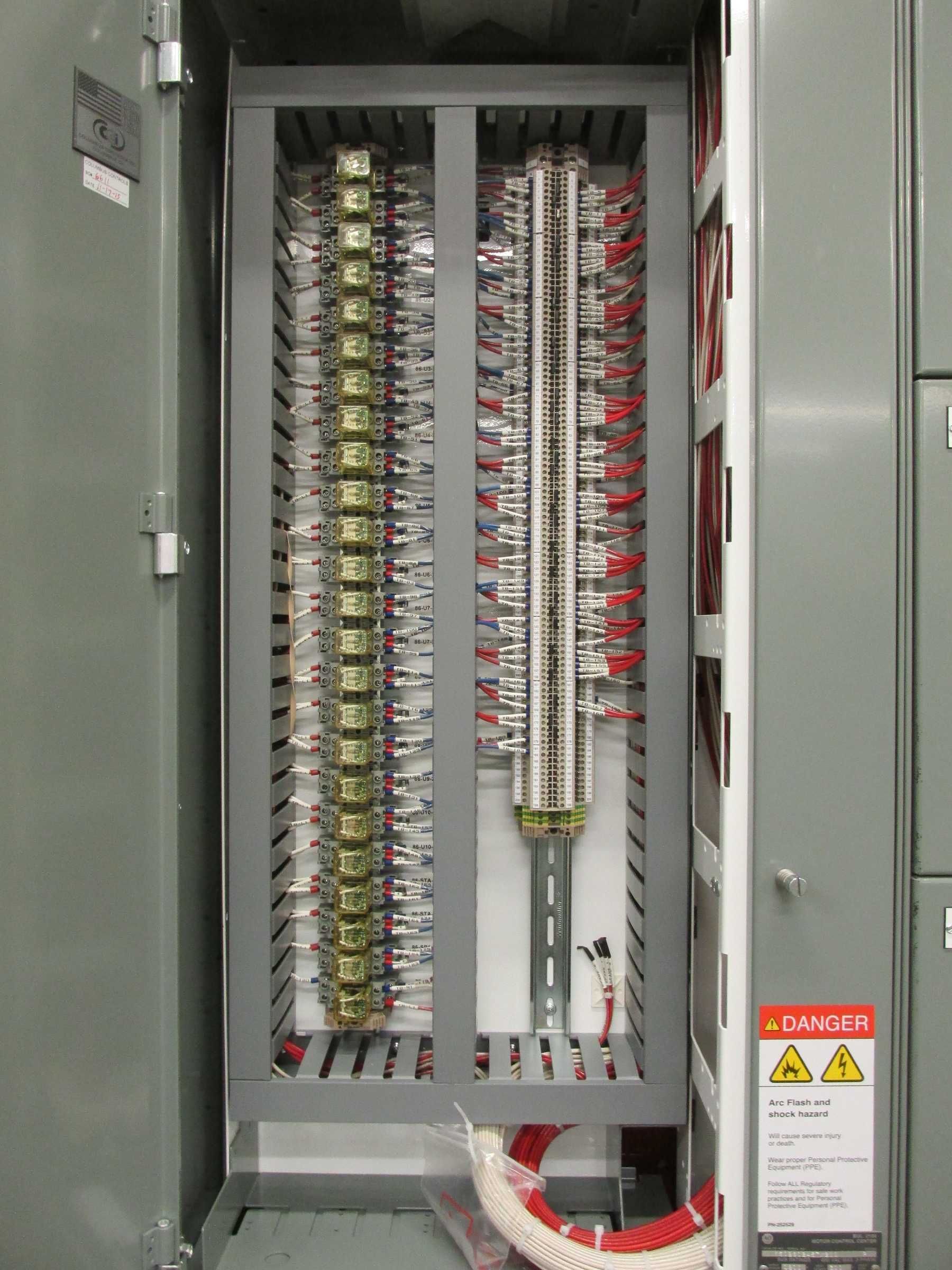 A large electrical box with a warning sign on it