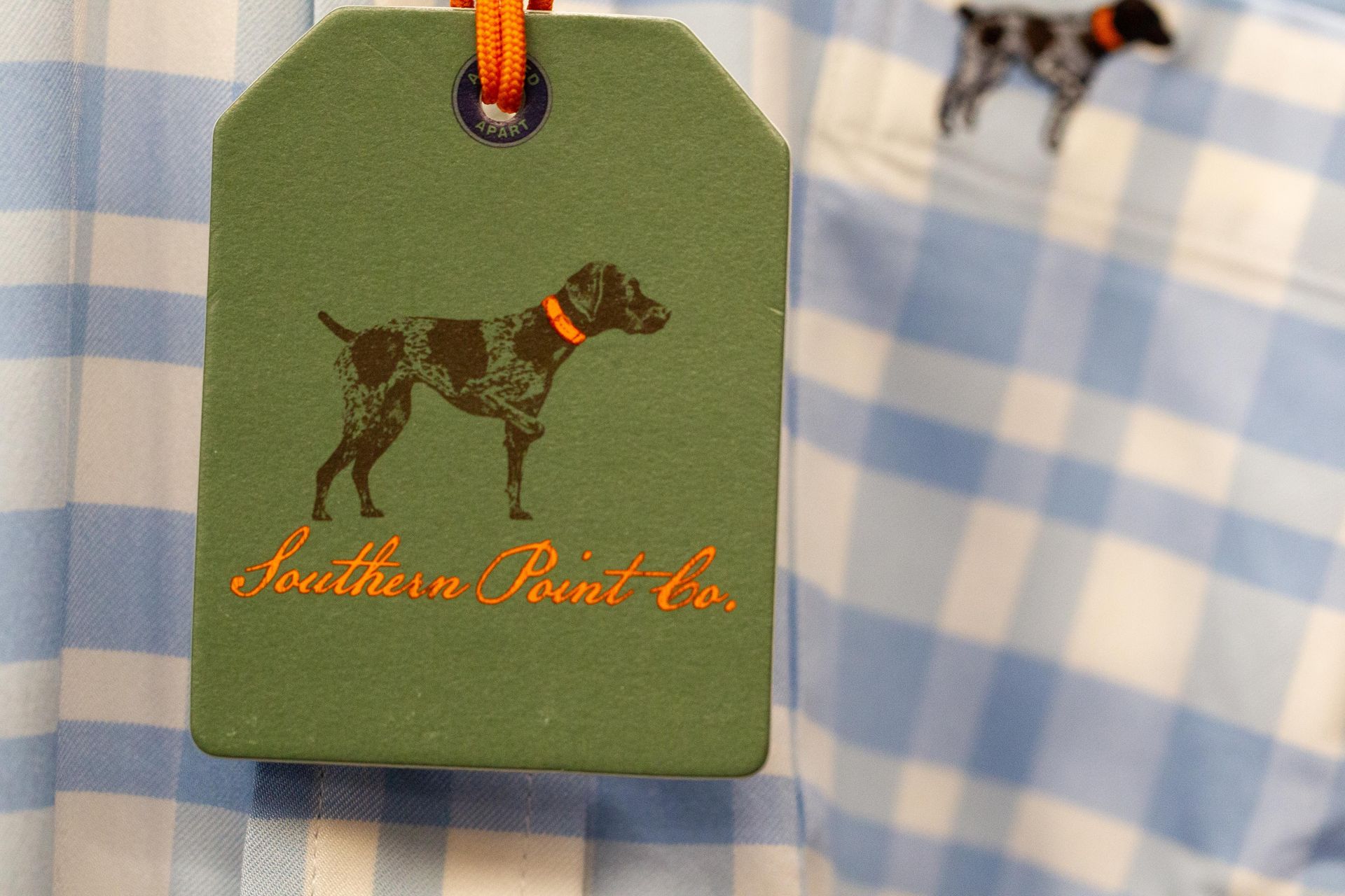 Green tag with a dog logo and 